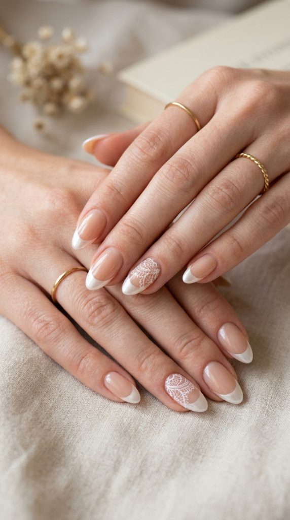 Nude manicure with one white lace accent nail
