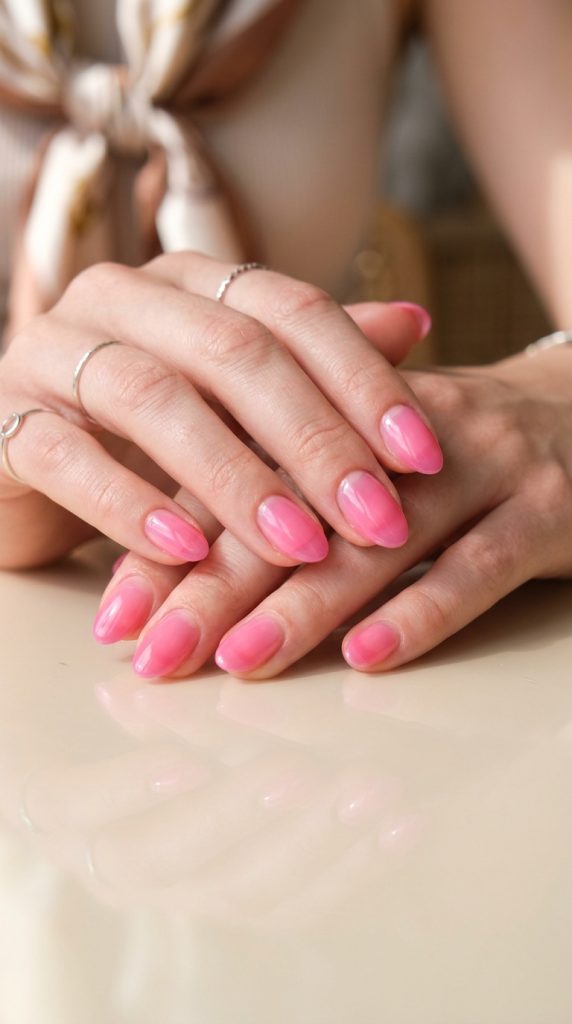 bubblegum pink jelly oval nails translucent glowing within natural nail visible white perspex bright direct light playful sweet viral 2026