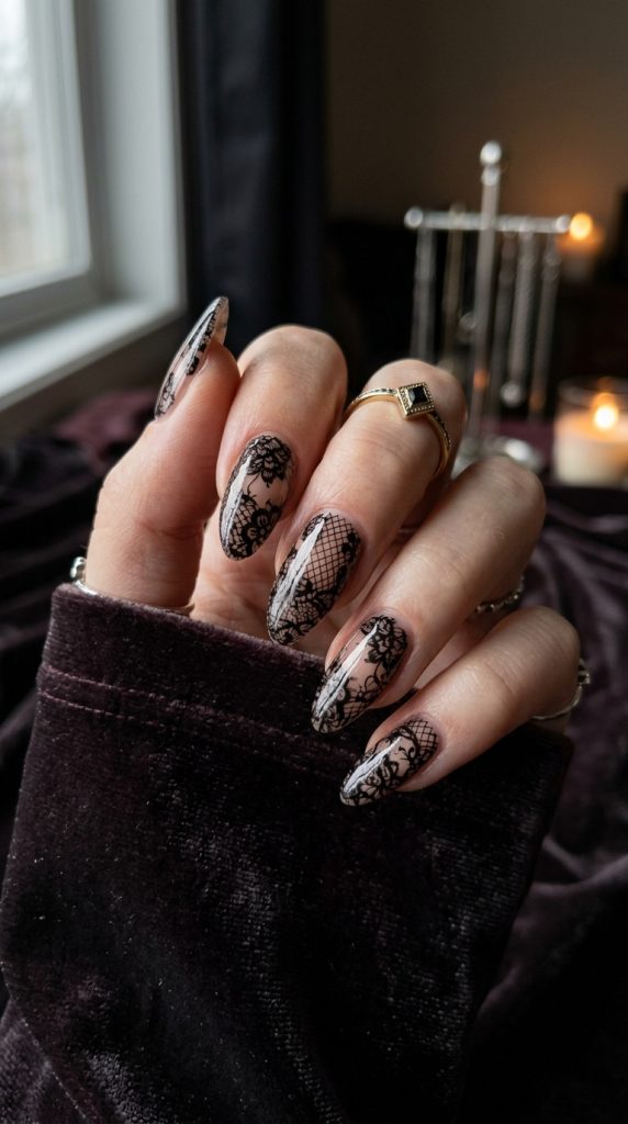Black lace nail art over a nude base