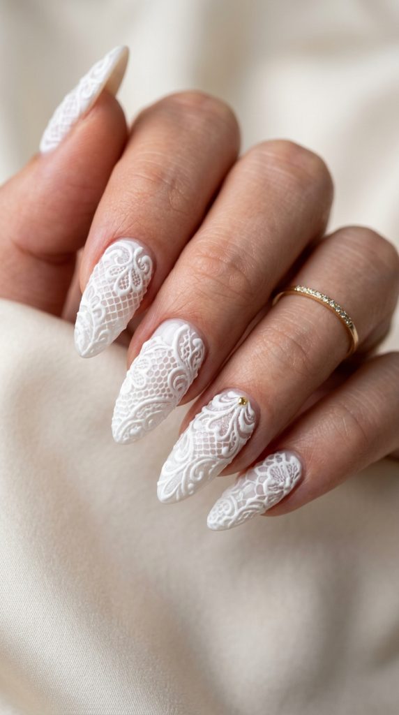 Raised 3D white lace gel nails on long almond nails