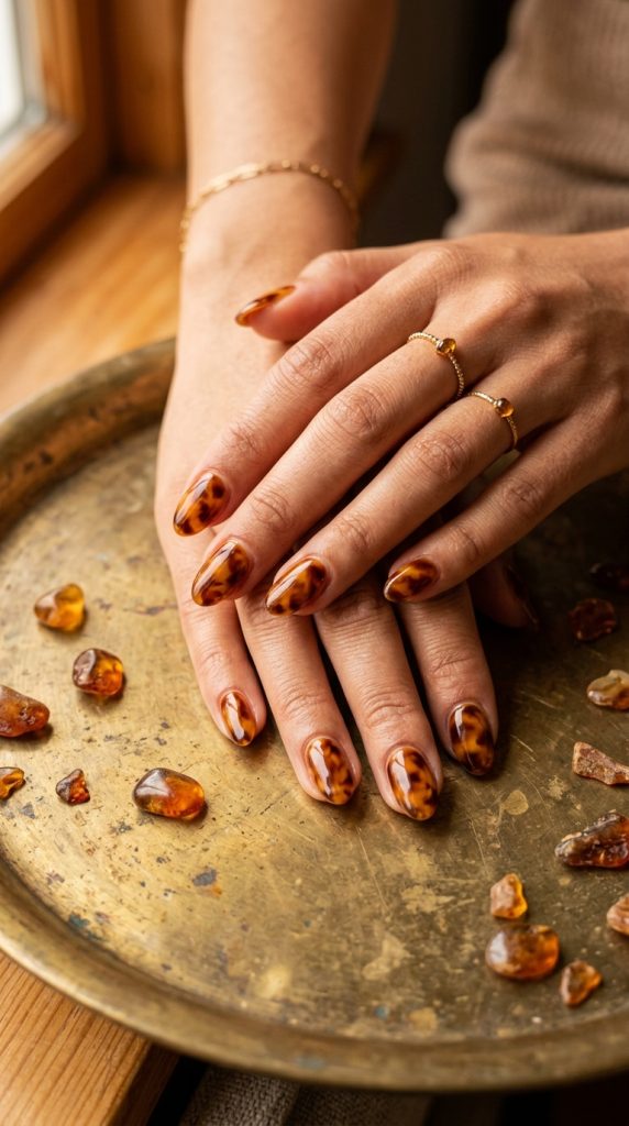 tortoiseshell oval nail designs warm amber caramel brown honey swirled different each nail aged brass amber pieces warm amber light vintage luxury 2026
