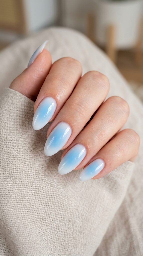 Baby blue aura nails with a soft sky-blue glow