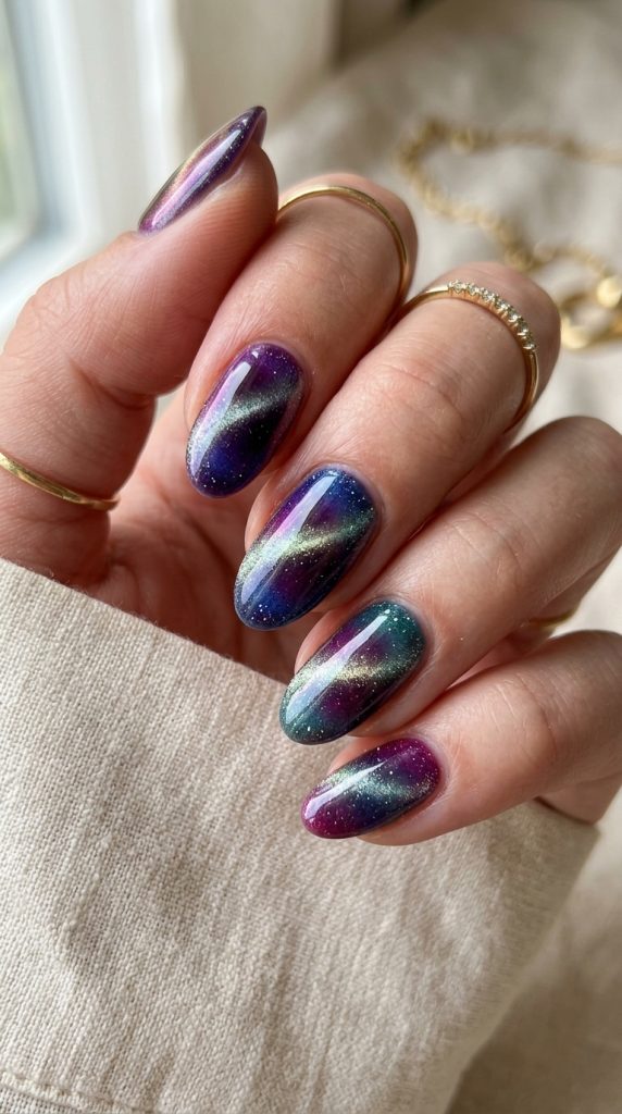 Cat-eye aura nails with a magnetic shimmer in jewel tones