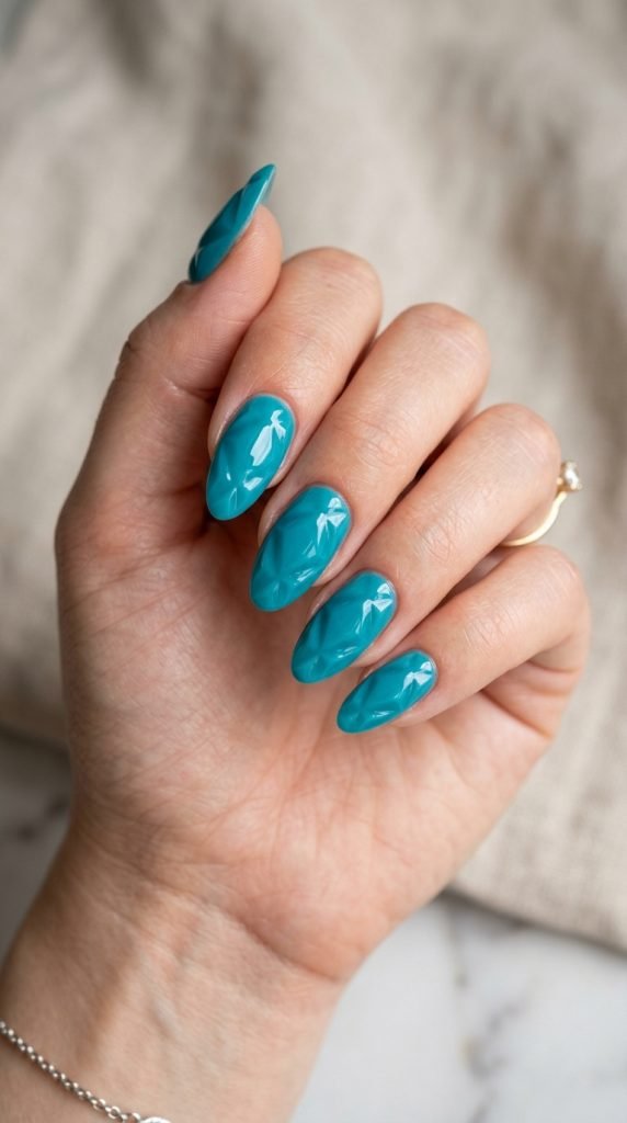 Teal blue dip nails showing vibrant turquoise tone and bold finish