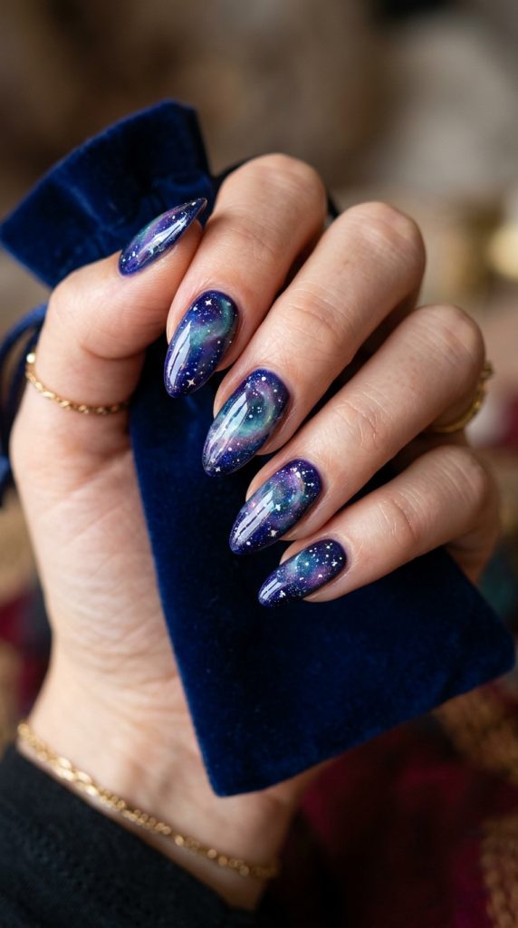 Galaxy aura nails with a deep cosmic glow and tiny stars