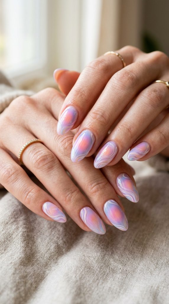 Aura swirl nails with a glowing marbled effect
