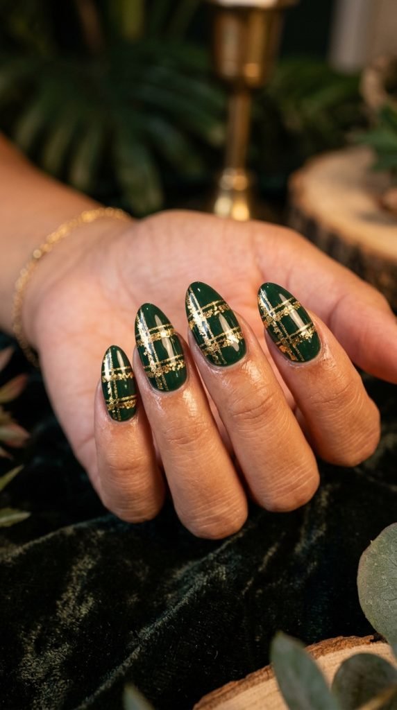 Deep forest green gel nails with gold leaf botanical accents